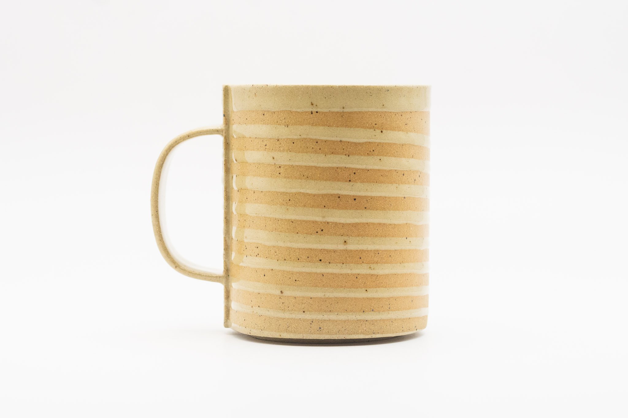 Tan handmade white spiral mug with handle