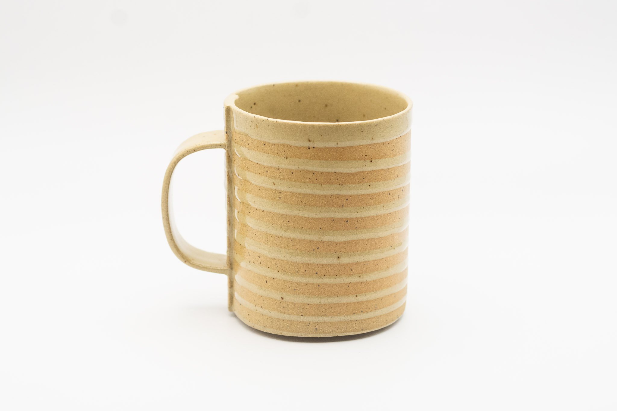 Tan handmade white spiral mug with handle