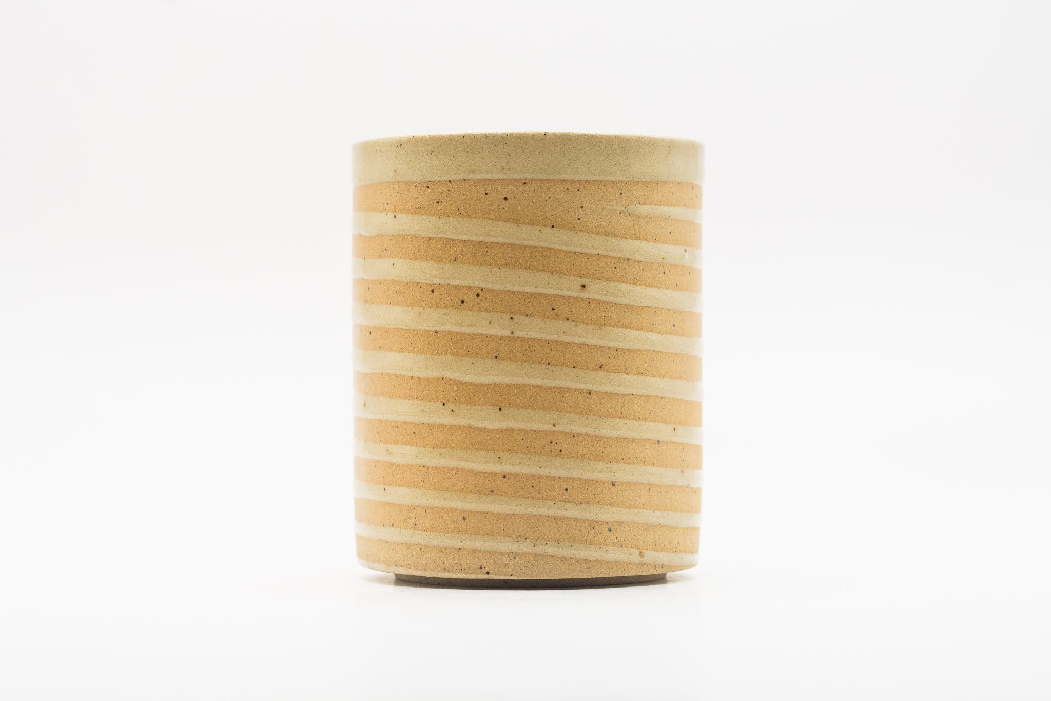 Tan handmade white spiral mug with handle