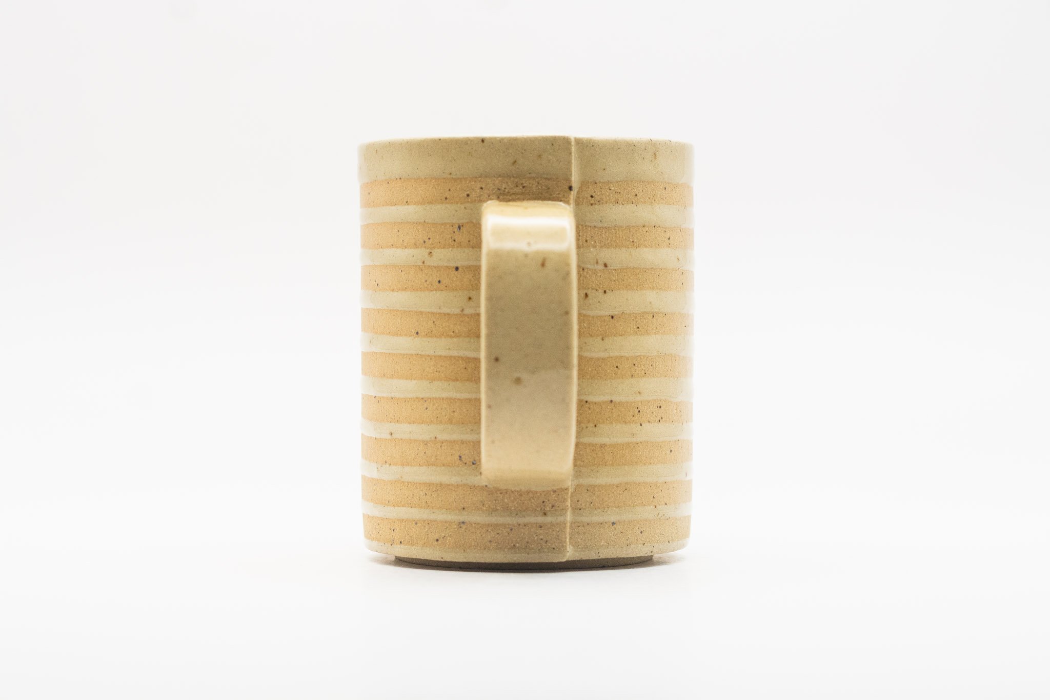 Tan handmade white spiral mug with handle