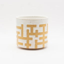 Handmade ceramic white tumbler with interlocking pattern